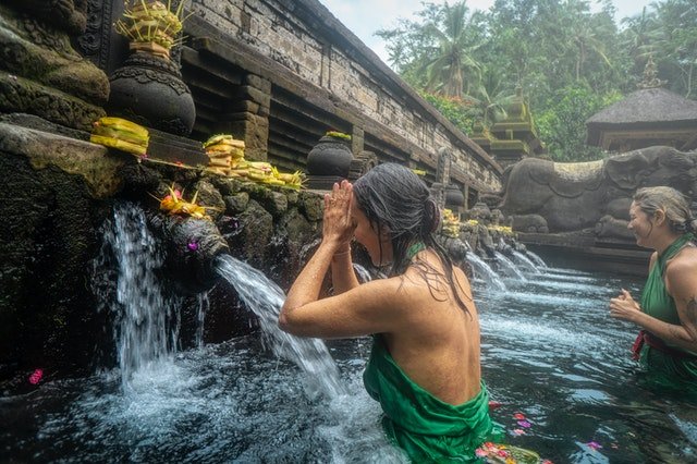 woman-standing-in-front-of-flowing-water-2166608-1